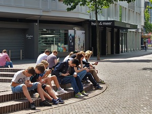 group of youths on mobile devices